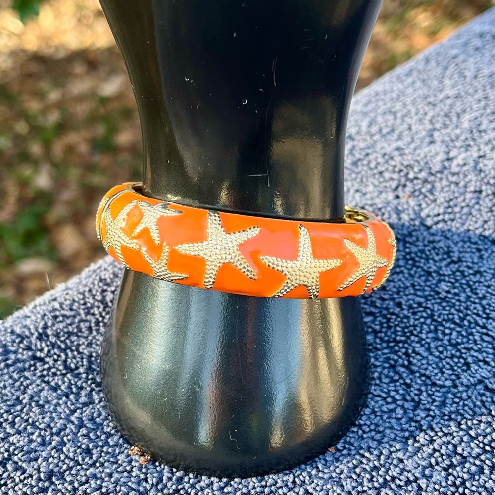 Talbot's bangle, orange enamel with gold textured starfish